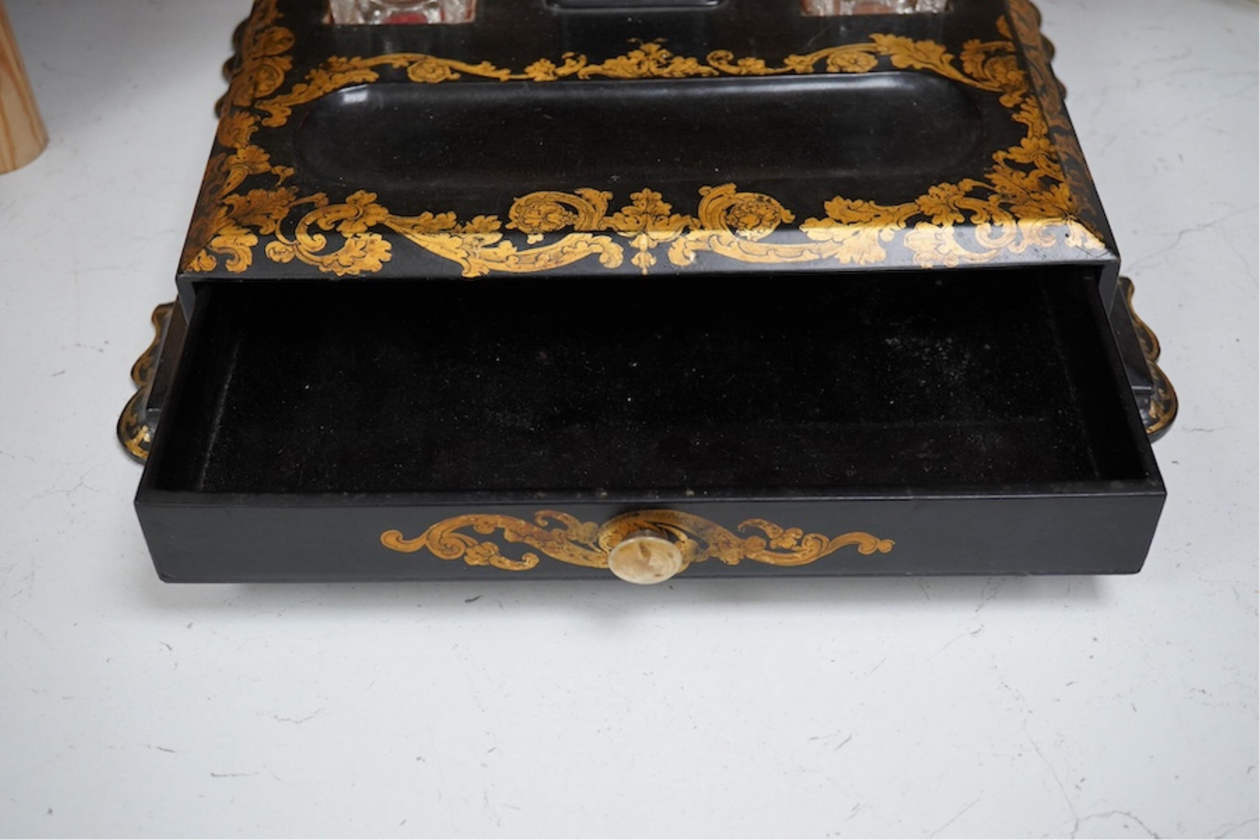 A Victorian black lacquer and gilt decorated two bottle ink stand with drawer. 36cm sided x 28cm deep. Condition - some lacquered missing.